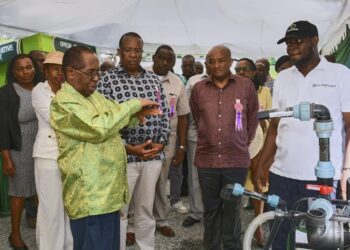 Co-operative Bank Group Managing Director Dr. Gideon Muriuki with board members at Mombasa ASK Show observing agritech innovations.