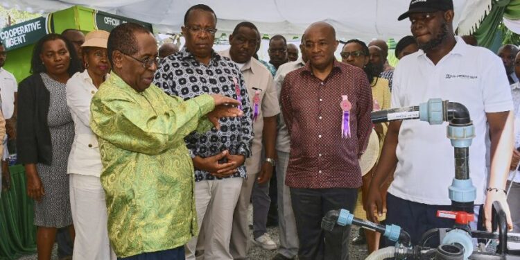 Co-operative Bank Group Managing Director Dr. Gideon Muriuki with board members at Mombasa ASK Show observing agritech innovations.